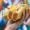 Hand holding three vegetarian tacos with lettuce, tomato, cheese, and plant-based meat, against a colorful graffiti background.