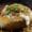 Loaded baked potato topped with sour cream, cheese, bacon, and chives.