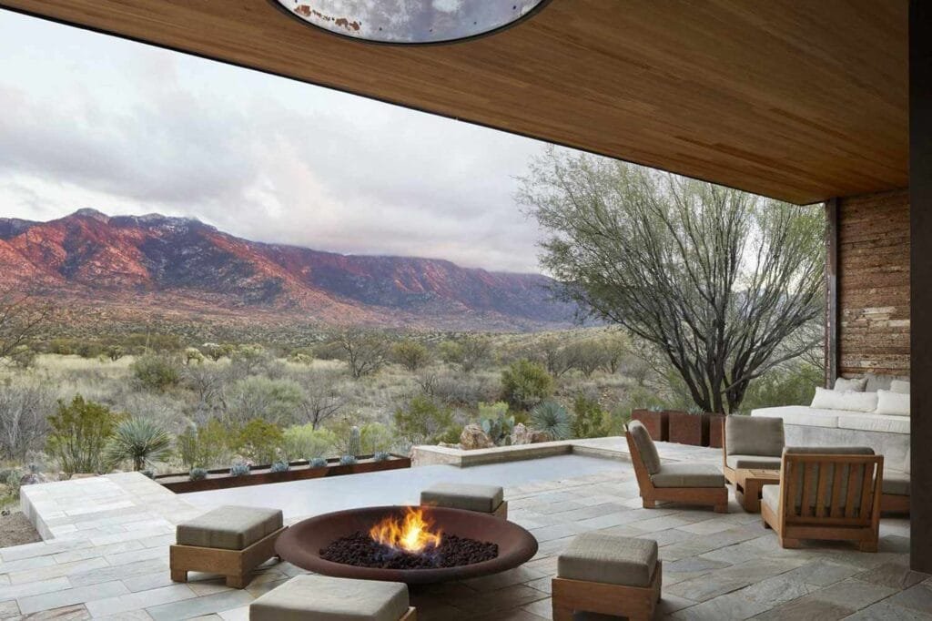 Luxury resort patio with firepit overlooking scenic mountain landscape