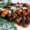 Slow-cooked meat in rich sauce topped with cheese and rosemary