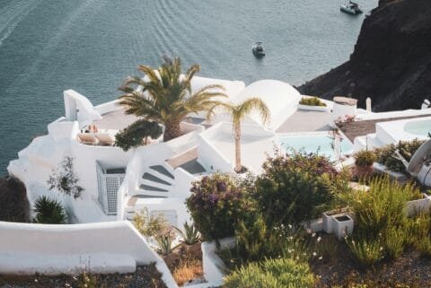 Romantic whitewashed cliffside resort with sea views and palm trees