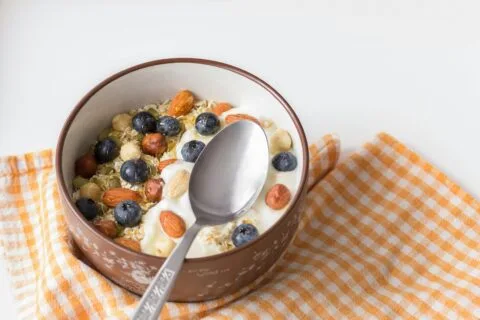 7-Day High Protein High Fiber Meal Plan to Power Your Life 74 Bowl of high-fiber yogurt with nuts and blueberries