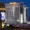 The illuminated facade of Westgate Las Vegas Resort and Casino at night, featuring tall white towers, glowing signage, and a large digital screen of Barry Manilow.