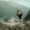 Woman doing yoga in Rishikesh with hills and temple in the background