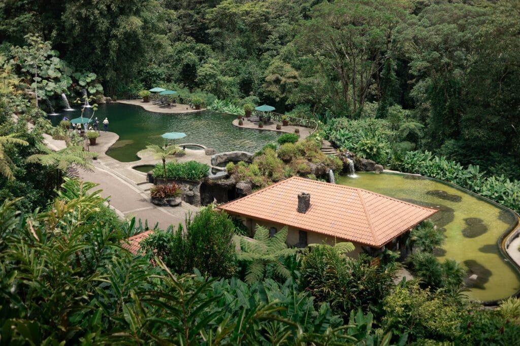 Uncover the 6 Best Resorts in Costa Rica for Pure Bliss 4 Lush jungle resort in Costa Rica featuring natural hot spring pools and tropical landscaping.