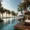 Luxurious beachfront resort in Puerto Rico with palm trees, ocean view, and poolside lounge chairs.