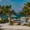 Luxury beachfront hotel pool area with palm trees on Paros Island