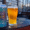 Bent Water Brewing Co. beer can and pint glass of golden ale on an outdoor table.