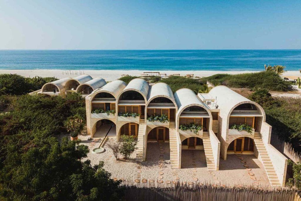 Modern beachfront hotel in Oaxaca with arched architecture and ocean views.
