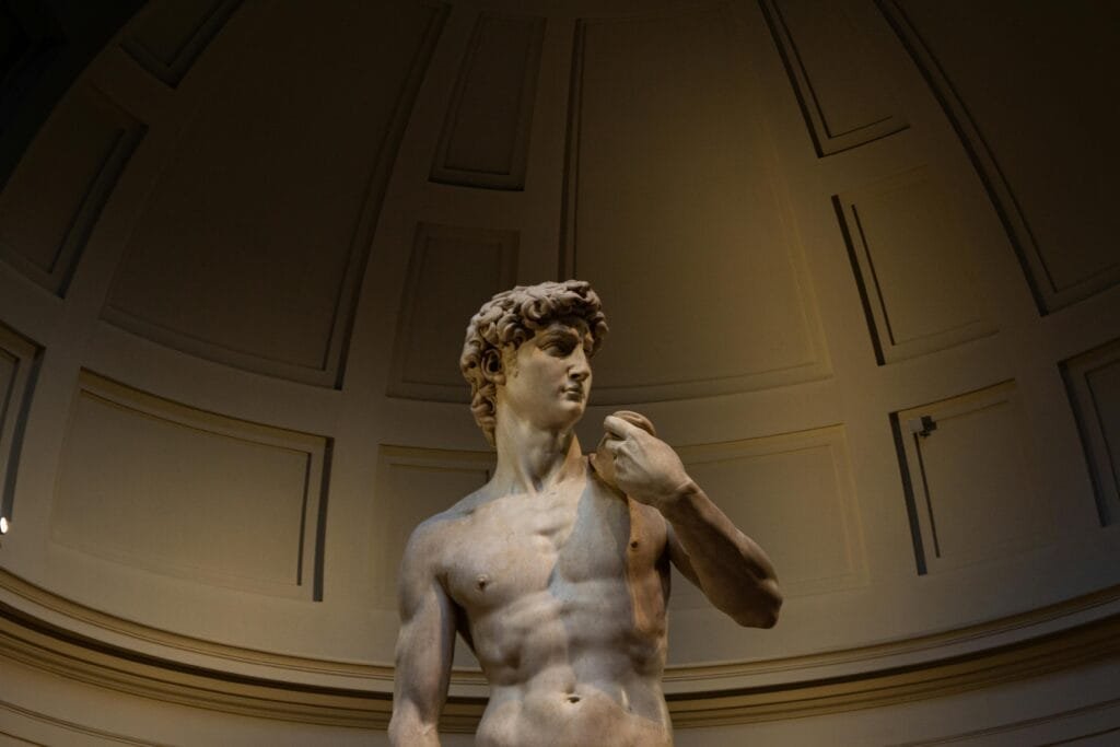 What to See in Florence Italy in 1 Day: Your Perfect Itinerary 4 Michelangelo’s statue of David displayed under a domed ceiling at the Accademia Gallery in Florence, Italy.