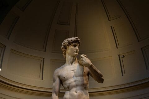 What to See in Florence Italy in 1 Day: Your Perfect Itinerary 14 Michelangelo’s statue of David displayed under a domed ceiling at the Accademia Gallery in Florence, Italy.