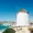 Iconic white windmills overlooking the sea in Mykonos, Greece.