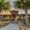 Entrance to Grills restaurant with palm trees and tropical landscaping.