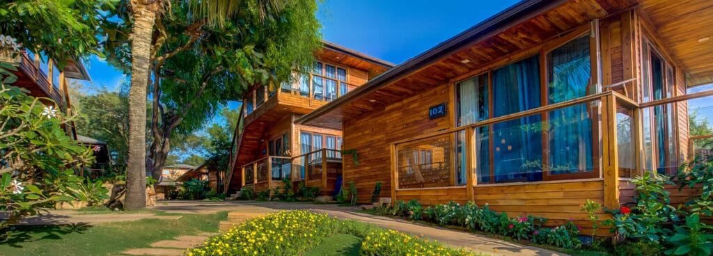 Wooden beachfront cottages at The Baga Beach Resort, Goa