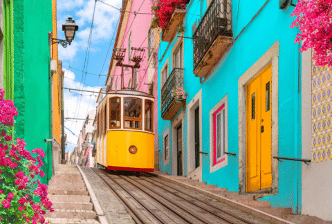 Colorful street in Lisbon, Portugal with a yellow tram passing