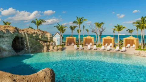 Resort pool with cabanas and ocean view at Grand Hyatt Baha Mar