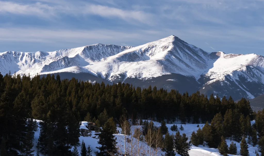 Sunlit Colorado mountains with forested slopes