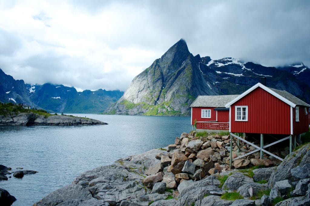 red cabin by a Norwegian fjord